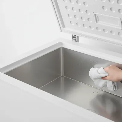 Clean and dry interior of a chest freezer after defrosting